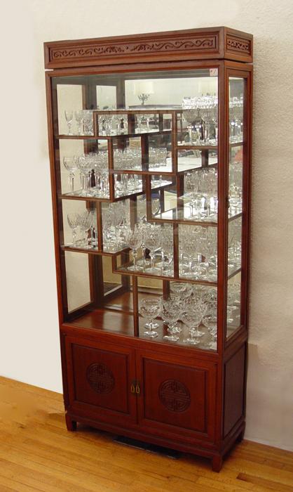 Appraisal: CHINESE ROSEWOOD DISPLAY CABINET Glass front with side opening doors