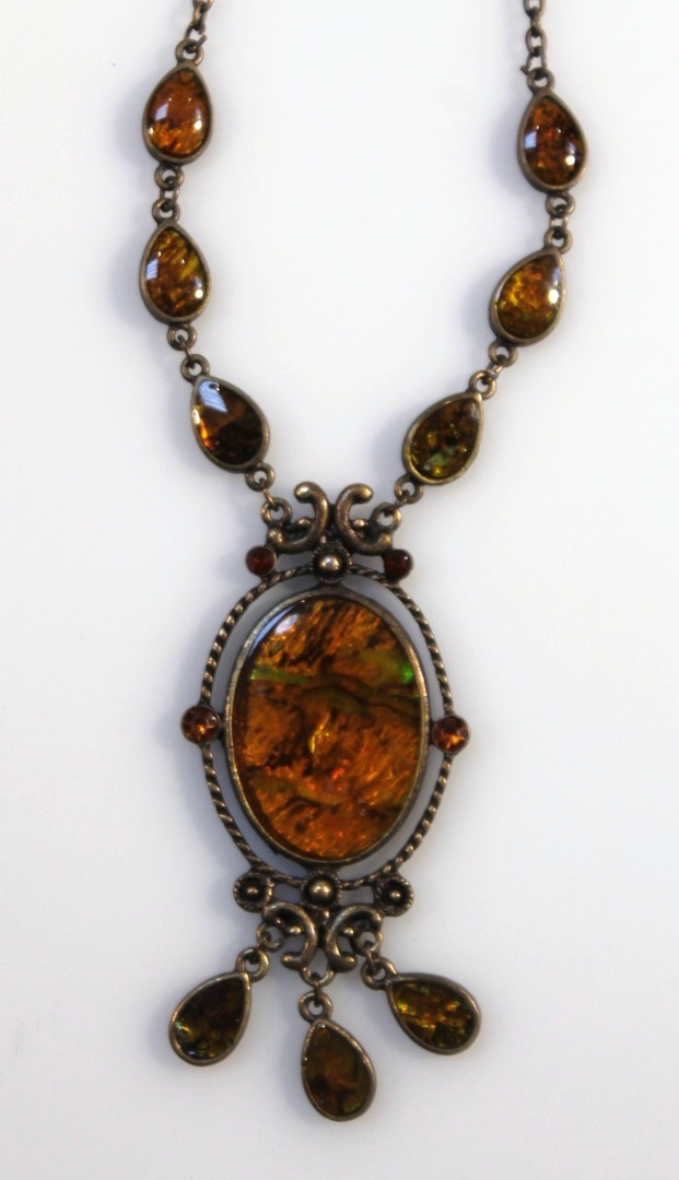 Appraisal: An Art Nouveau design amber finish pendant the oval centre