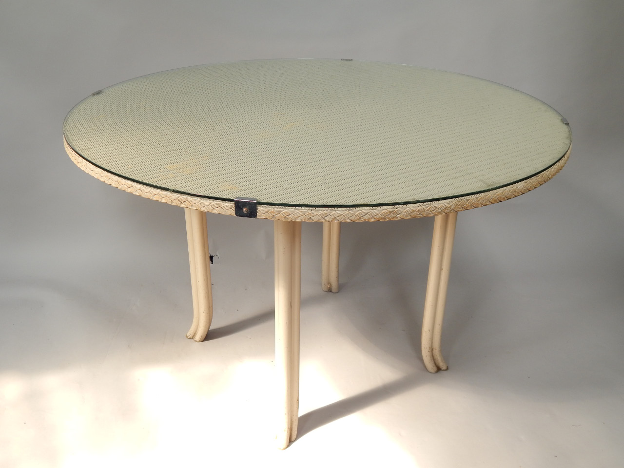 Appraisal: A Lloyd Loom circular table with plate glass top cm