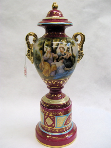 Appraisal: CONTINENTAL STYLE PORCELAIN URN depicting colorful outdoor scenes of people