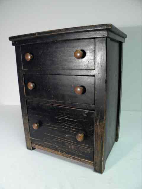 Appraisal: th century ebonized wood three-drawer miniature chest each draw with