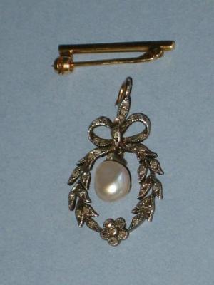 Appraisal: A DIAMOND AND PEARL PENDANT comprising bow and wreath set