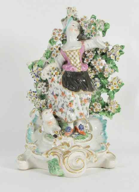 Appraisal: A Derby figure of a shepherdess in a floral bocage