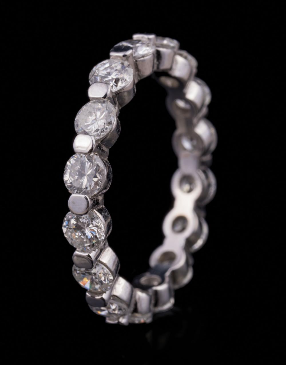 Appraisal: Platinum and Diamond Eternity Ring comprised of bezel set round