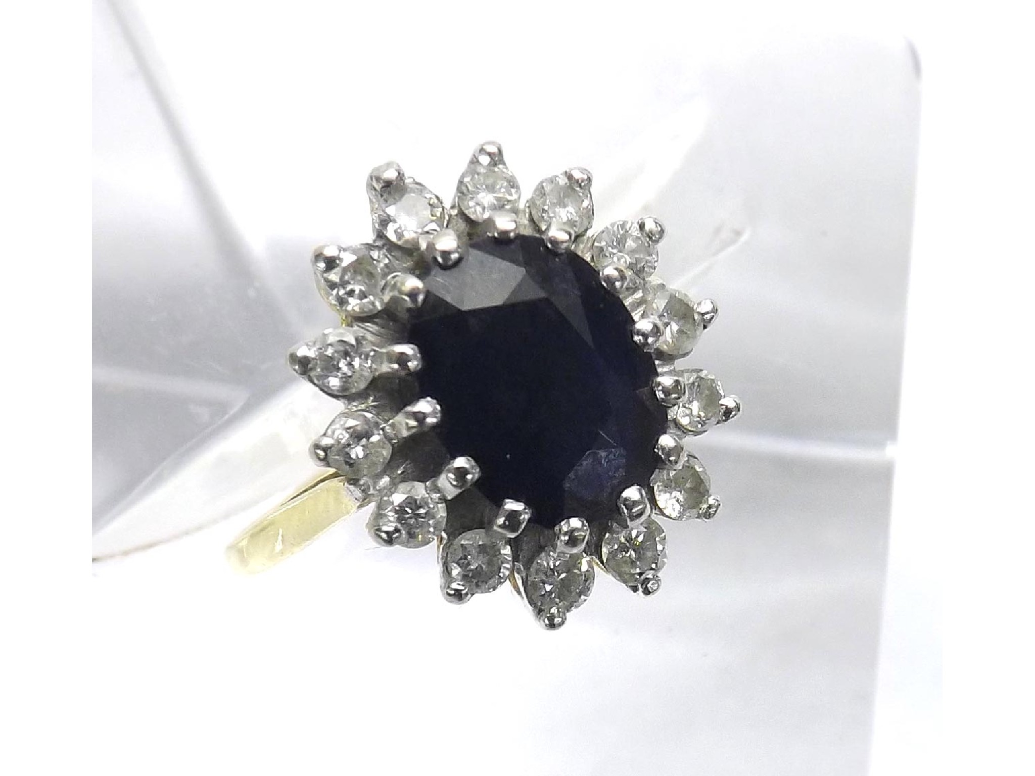 Appraisal: k sapphire and diamond cluster ring the oval dark sapphire