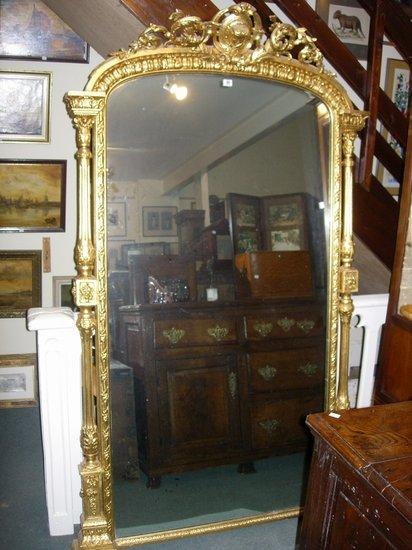 Appraisal: A LARGE TH CENTURY GILT OVAL MANTEL MIRROR with mask