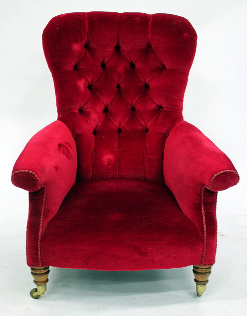 Appraisal: AN OLD RED DRAYLON BUTTON UPHOLSTERED ARMCHAIR with turned tapering