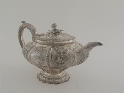 Appraisal: A George IV embossed teapot on a raised shaped circular