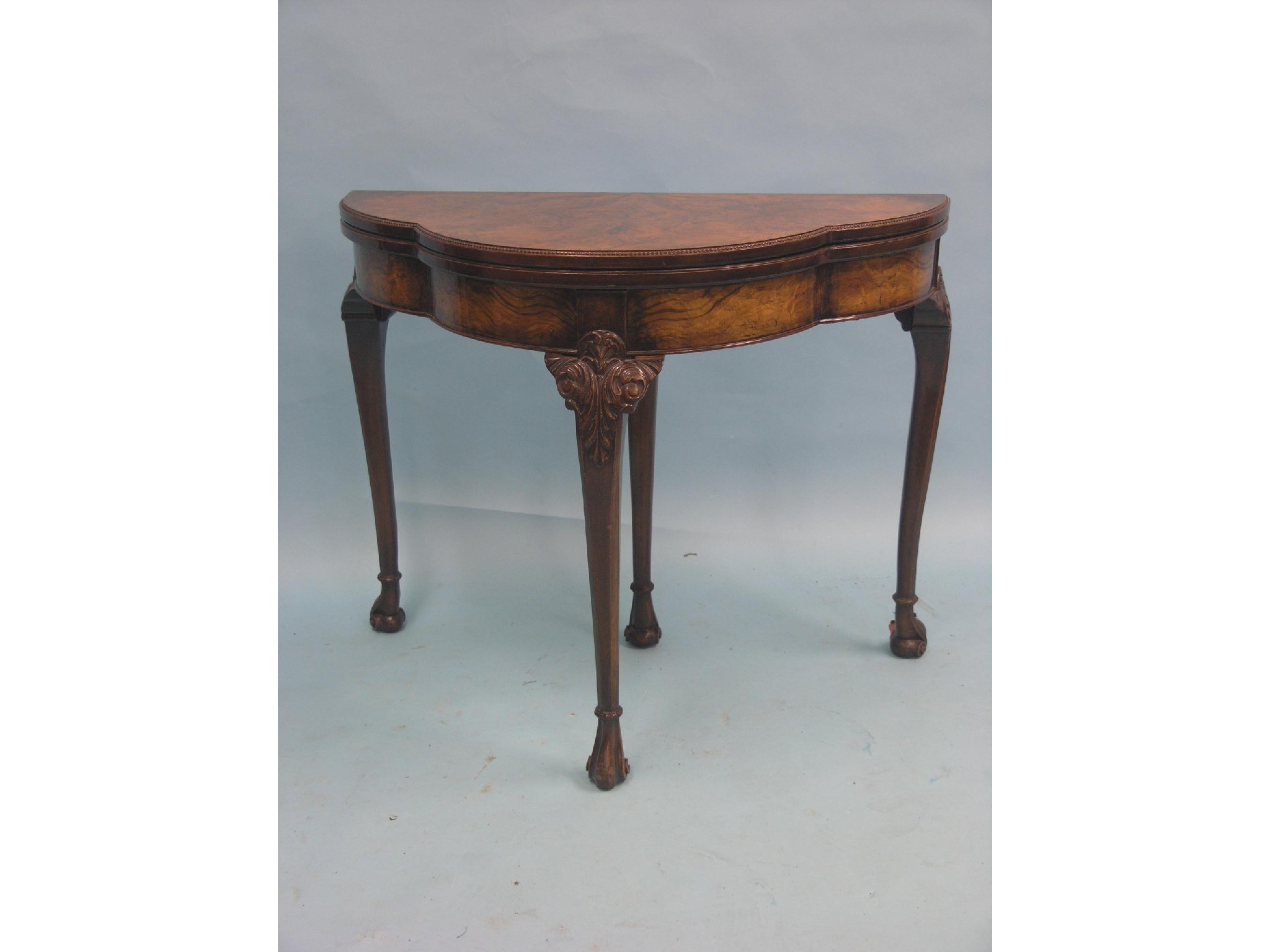 Appraisal: A good burr walnut card table lobed half-round form with