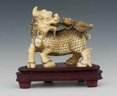 Appraisal: A Carved Ivory Kylin The well carved mythical beast Qilin