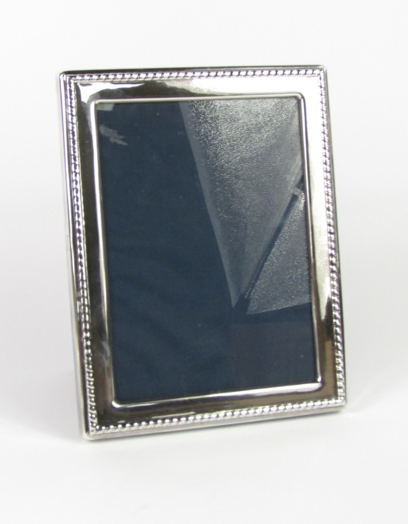 Appraisal: A silver strut photograph frame with a fluted edge Sheffield