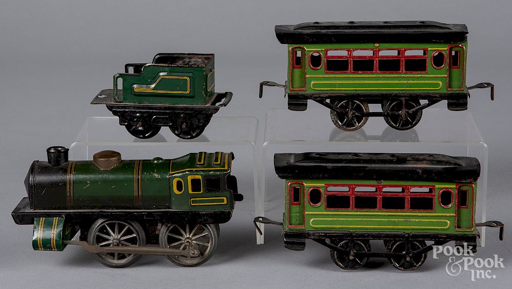 Appraisal: Tin litho wind-up four piece train set Tin litho wind-up