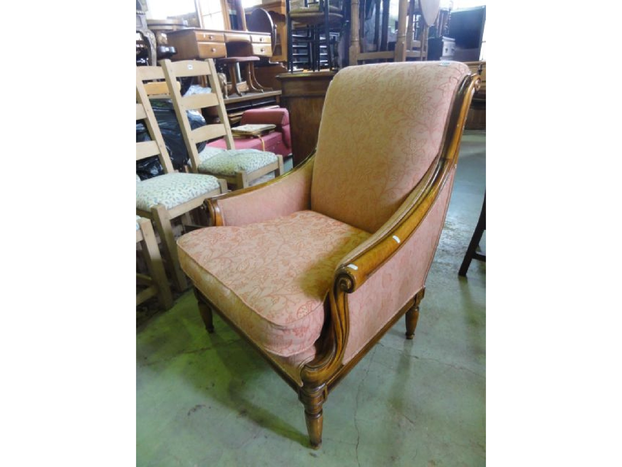 Appraisal: A reproduction Regency style armchair with polished scrolled show wood