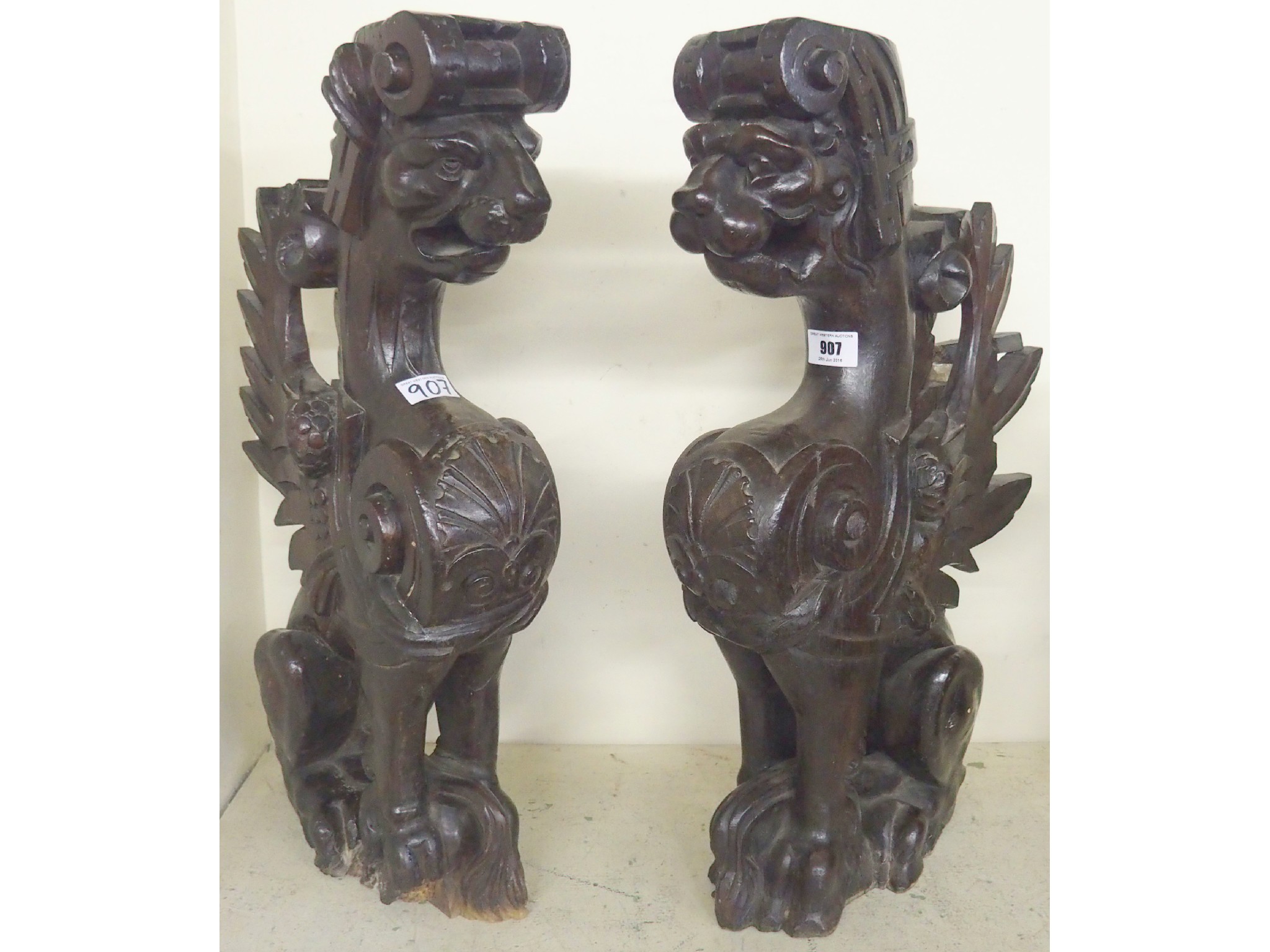 Appraisal: Two carved mahogany lion brackets