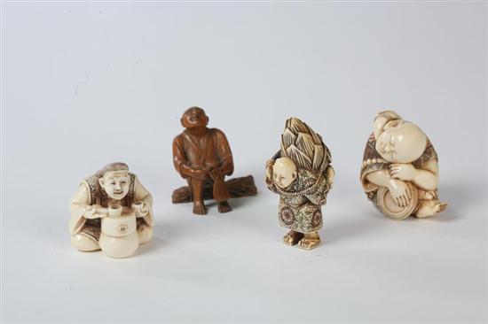 Appraisal: FOUR CARVINGS Japanese th century Three ivory netsukes with inked