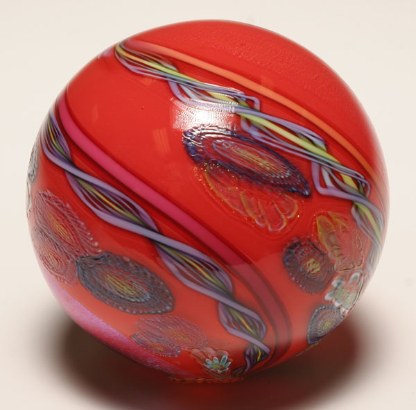 Appraisal: James Nowak red studio glass orb Purple latticino millefiore and