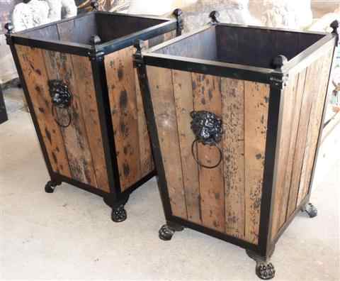 Appraisal: PAIR OF BLACK PAINTED IRON AND WOOD JARDINAIRES with lion's