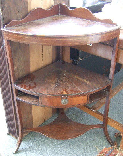 Appraisal: A Regency mahogany corner washstand with a shaped back and