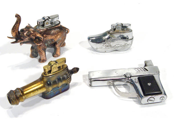 Appraisal: Four novelty lighters including an Aurora pistol a cannon etc