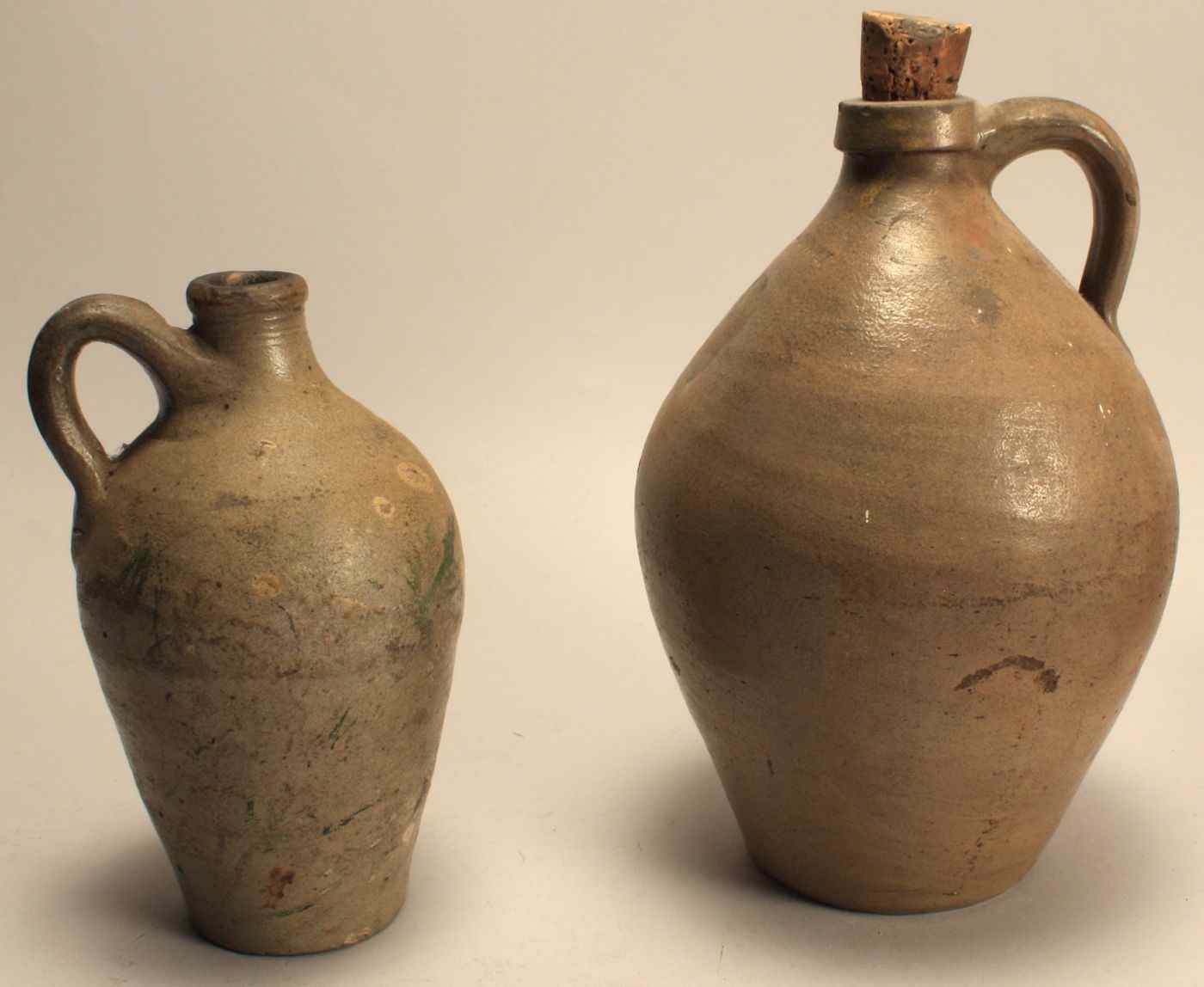 Appraisal: TWO SMALL CHARLESTOWN STONEWARE JUGS th CenturyIn ovoid form Heights