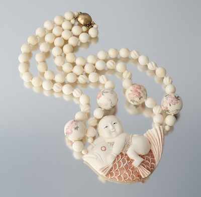 Appraisal: A Carved Ivory Necklace with Boy and Fish Design Carved