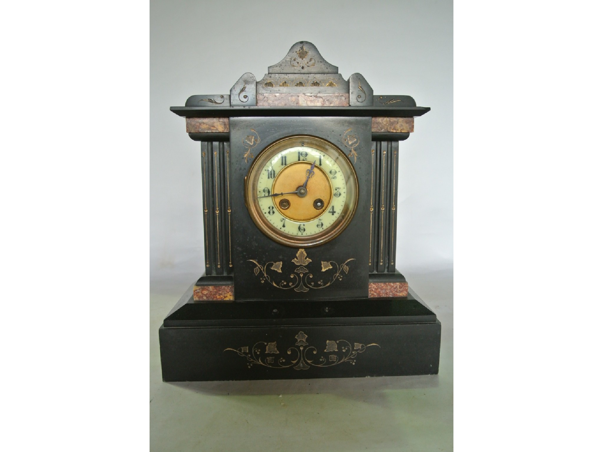 Appraisal: A polished black slate mantle clock of architectural form with