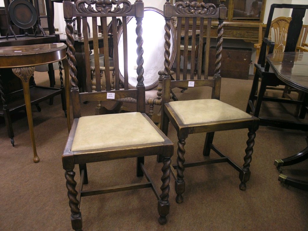 Appraisal: A set of four solid dark oak dining chairs with