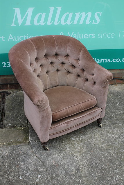 Appraisal: A HOWARD SONS BUTTON UPHOLSTERED SMALL ARMCHAIR on turned mahogany