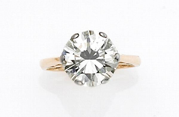 Appraisal: A diamond platinum and fourteen karat gold solitaire ring centering