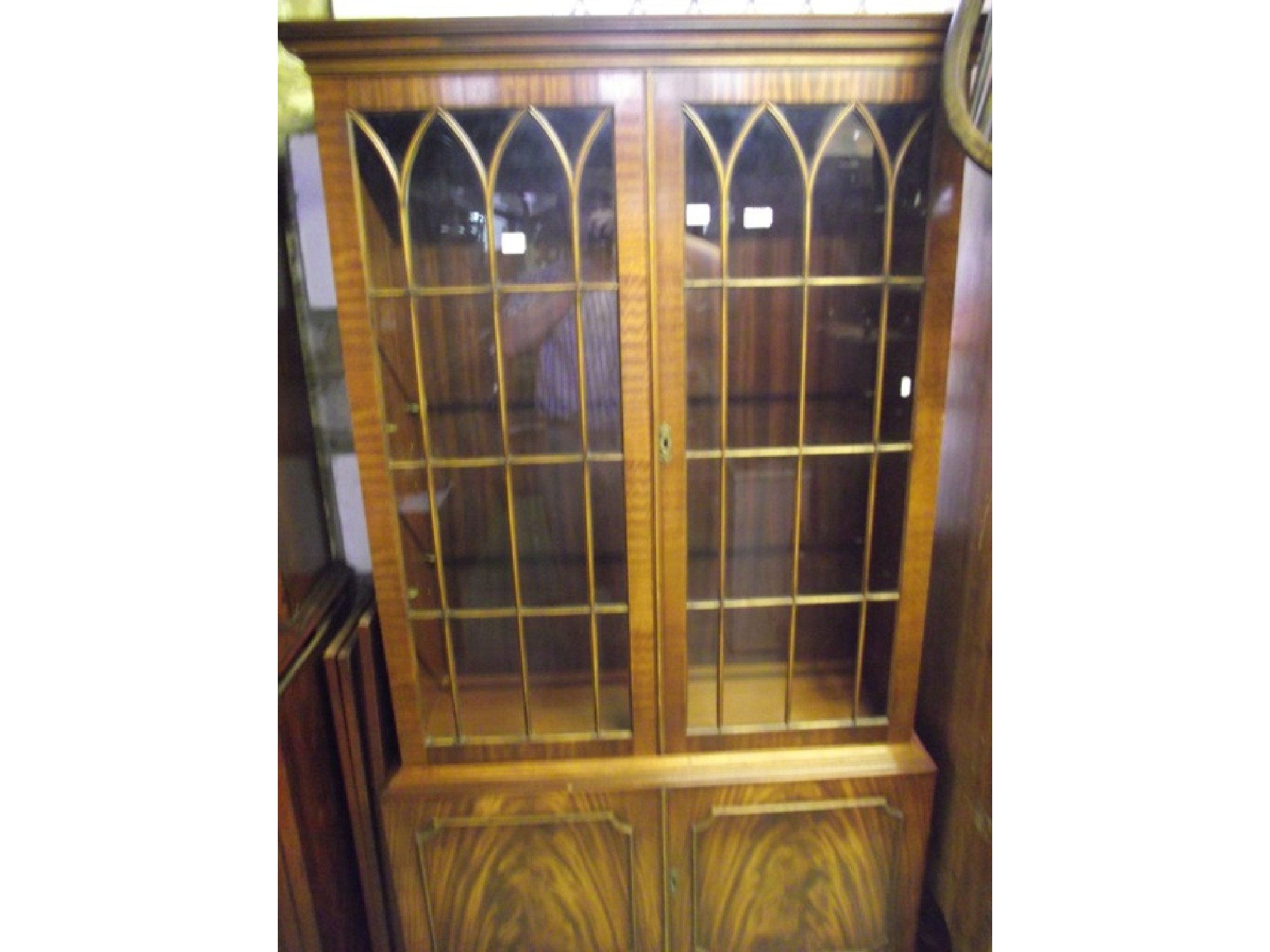 Appraisal: A reproduction mahogany freestanding side cabinet bookcase in the Georgian