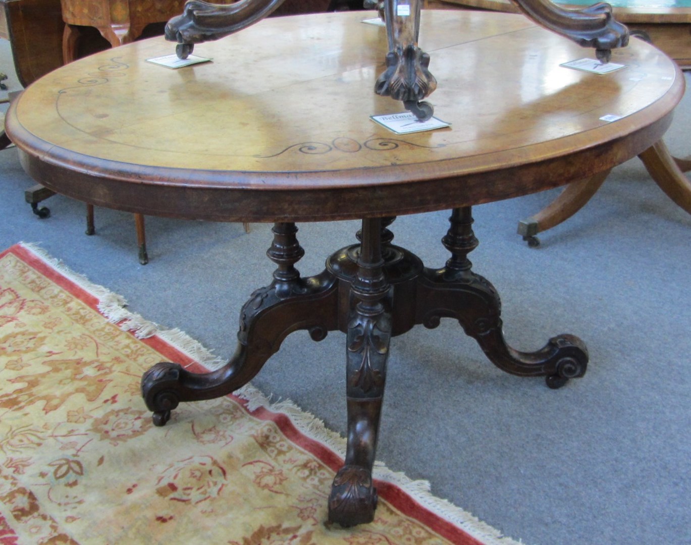 Appraisal: A Victorian marquetry inlaid walnut oval loo table on four