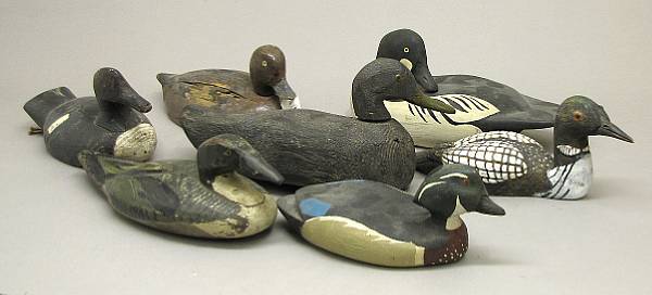 Appraisal: A group of seven carved and painted wood duck decoys