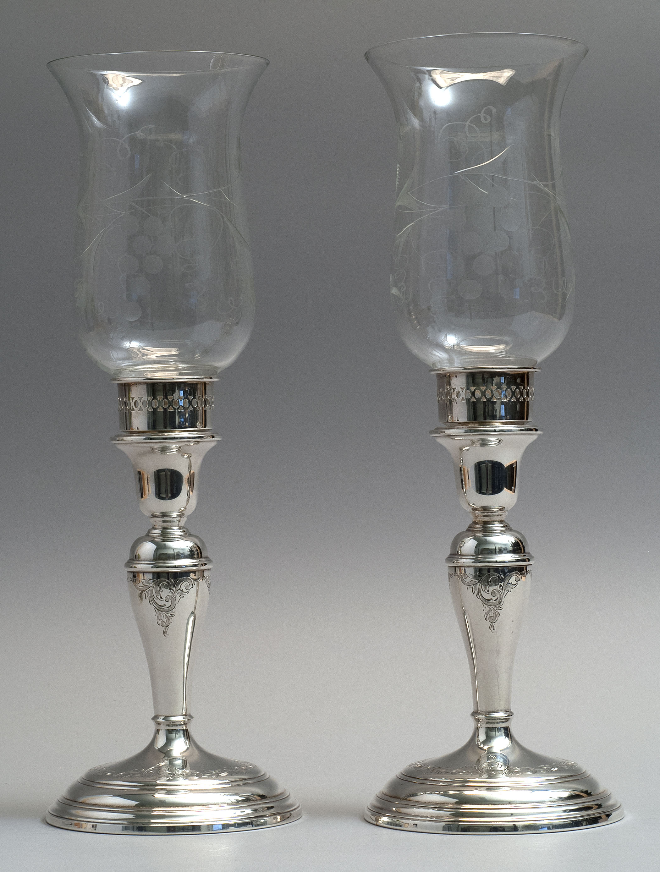 Appraisal: PAIR OF BIRKS STERLING SILVER WEIGHTED CANDLESTICKS With hurricane shades