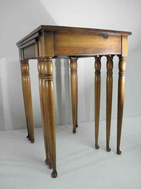 Appraisal: Three pine nesting tables with maple finish and petite slipper