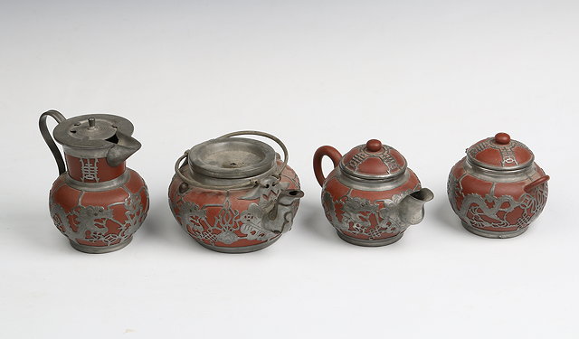 Appraisal: A CHINESE YIXING STYLE FOUR PIECE TEASET with applied paktong