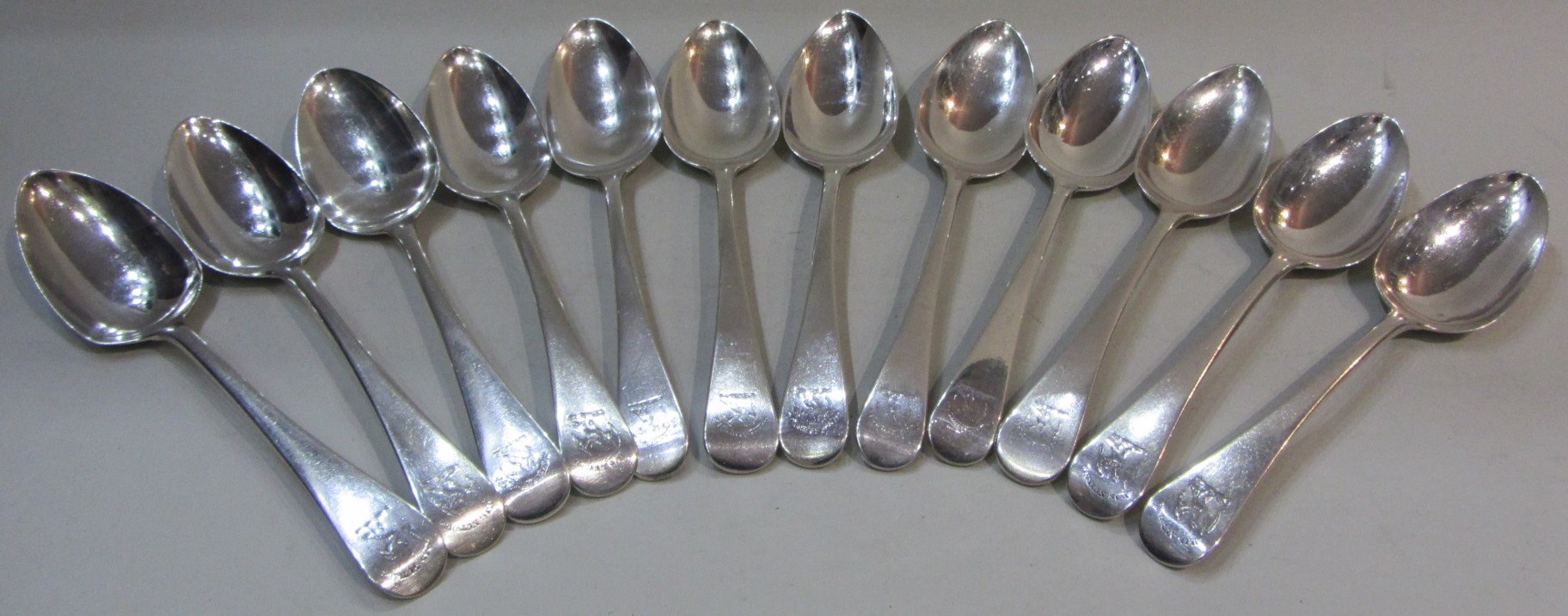 Appraisal: Twelve silver Old English pattern tablespoons all crest and motto