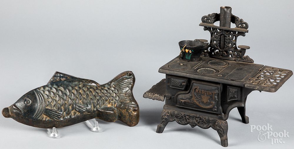 Appraisal: Crescent doll stove and a cast fish mold Crescent doll