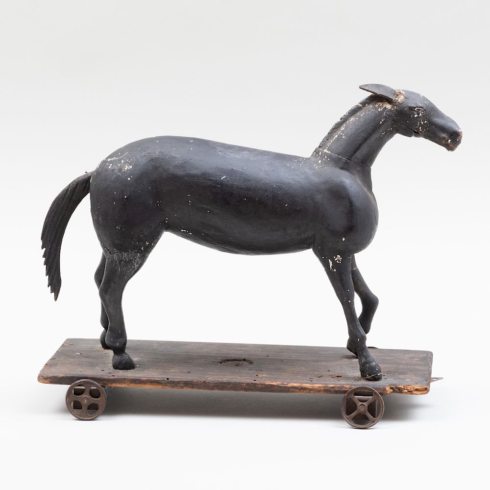 Appraisal: Black Painted Wood Model of a Horse on a Trolley