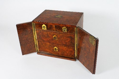 Appraisal: A figured walnut smoker's humidor fitted five drawers with countersunk