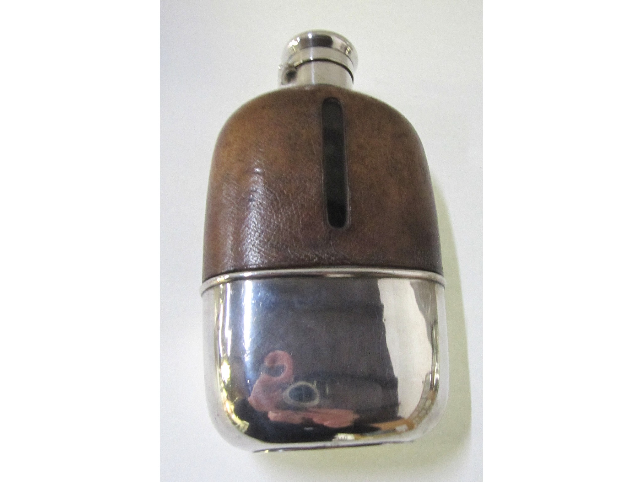 Appraisal: A large sterling silver and leather mounted spirit flask