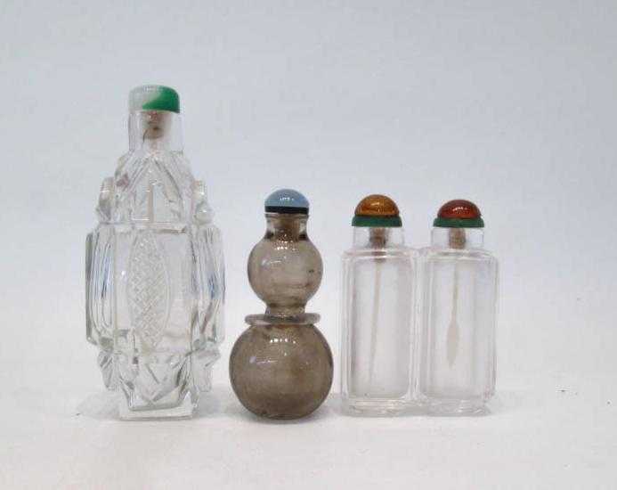 Appraisal: THREE CHINESE CRYSTAL SNUFF BOTTLES one cut crystal flattened oval