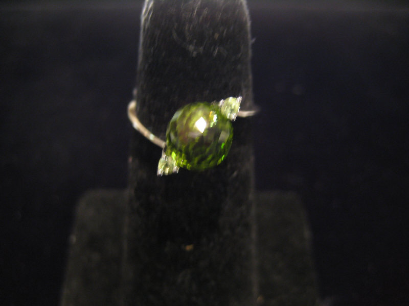 Appraisal: PERIDOT AND DIAMOND RING k white gold ring set with