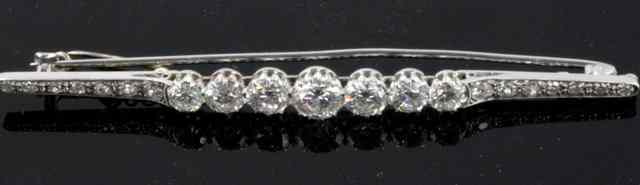 Appraisal: A diamond bar brooch with seven graduating stones flanked by