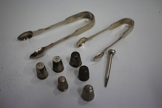 Appraisal: TWO SILVER SUGAR TONGS together with various thimbles