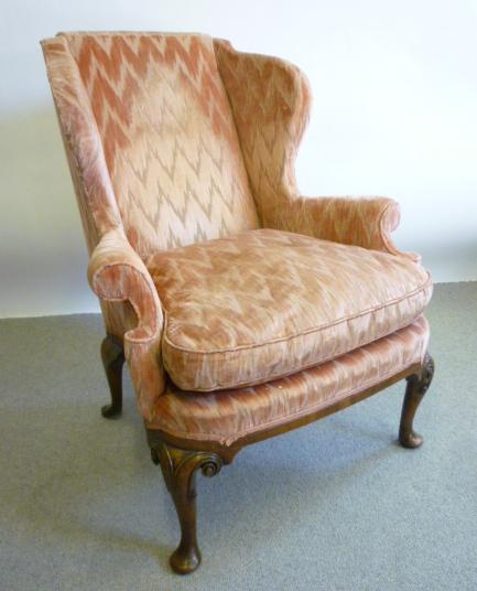 Appraisal: A WALNUT FRAMED WING ARMCHAIR of Georgian design upholstered in