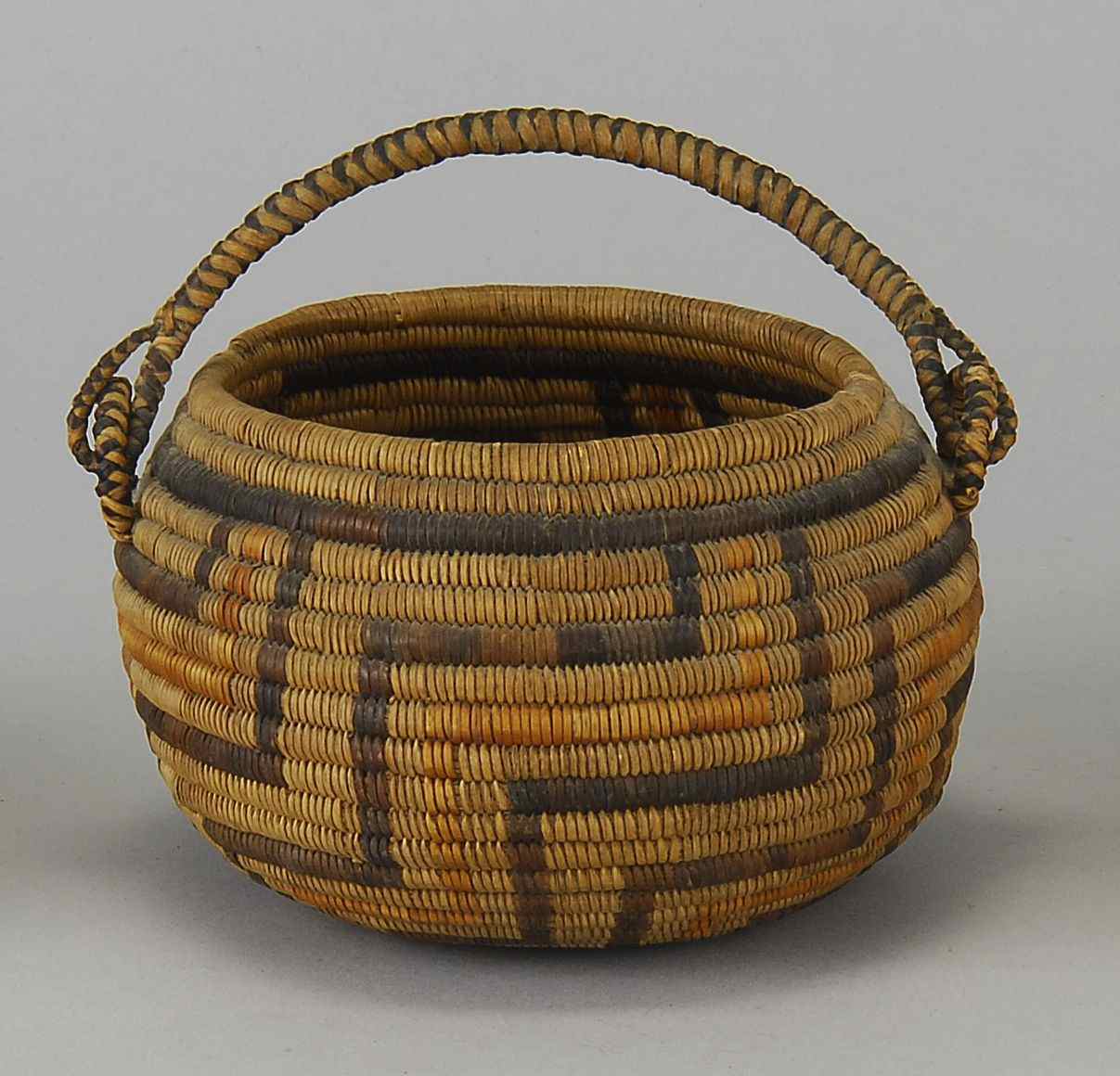 Appraisal: CALIFORNIA INDIAN HANDLED BASKETCirca In a black yellow and beige