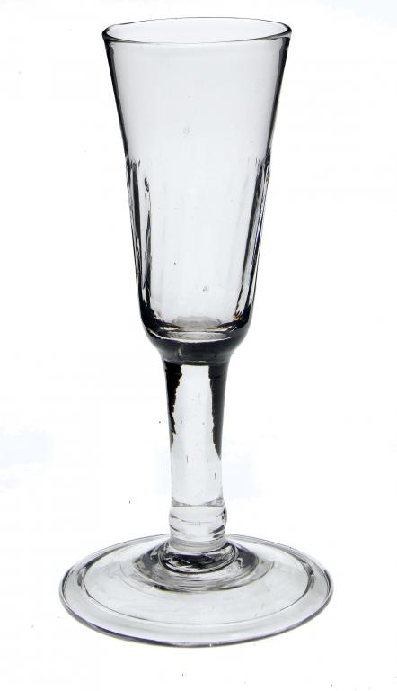 Appraisal: AN ALE GLASS the fluted rounded funnel bowl on solid