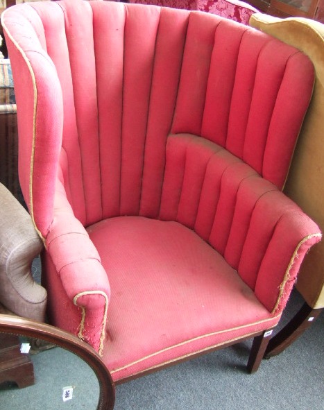 Appraisal: An th century style high back tub armchair raised on