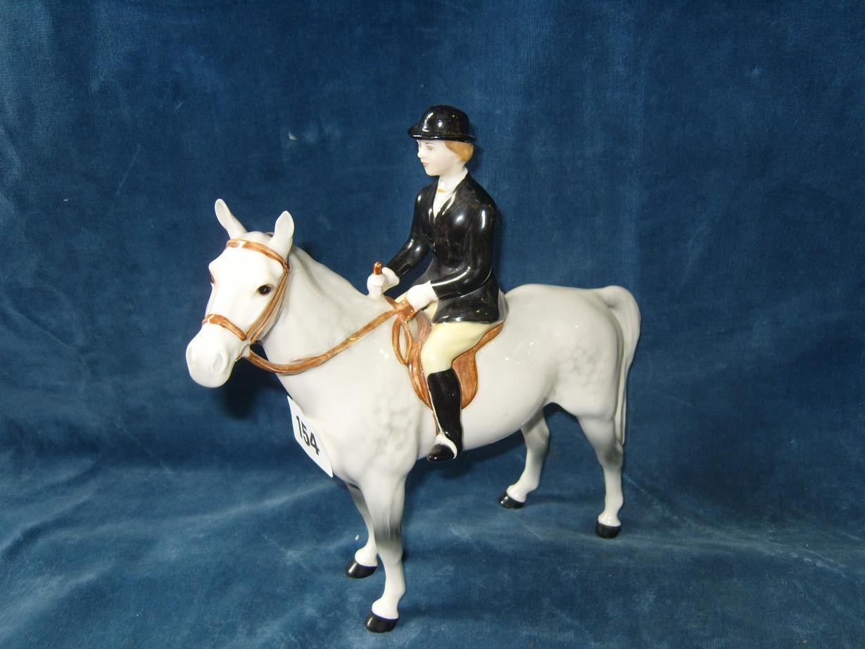 Appraisal: A Beswick model of a black jacketed huntswoman on a