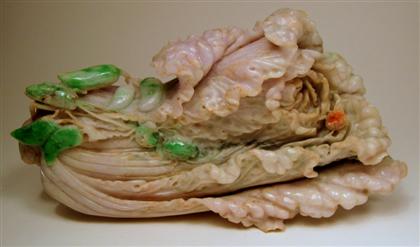 Appraisal: Chinese jadeite cabbage modelTypical long vegetable form carved to show